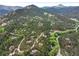 Stunning aerial view of a mountain community with lush forests and winding roads at 207 Kelly E Rd, Boulder, CO 80302