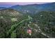 Picturesque aerial view of a treelined mountain community with winding roads at dusk at 207 Kelly E Rd, Boulder, CO 80302