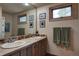 Bathroom featuring a double vanity with tiled backsplash and wood-framed windows at 207 Kelly E Rd, Boulder, CO 80302