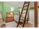 Bright bedroom featuring a canopy bed with ladder to lofted space and green walls at 207 Kelly E Rd, Boulder, CO 80302