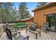 Outdoor deck with patio furniture and wooded views creating a peaceful outdoor setting at 207 Kelly E Rd, Boulder, CO 80302