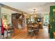 Open-concept dining area showcasing hardwood floors, a large dining table, and seamless flow into the living room at 207 Kelly E Rd, Boulder, CO 80302
