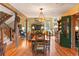 Open dining room featuring hardwood floors, stone fireplace, and staircase to the second level at 207 Kelly E Rd, Boulder, CO 80302