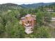 Aerial view of mountain home featuring an outdoor deck and stone chimney at 207 Kelly E Rd, Boulder, CO 80302