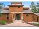 Unique wood clad home with dormer windows and a covered front porch and landscaped yard at 207 Kelly E Rd, Boulder, CO 80302