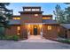 Charming home featuring covered entryway with decorative columns, dark green front door, and manicured landscaping at 207 Kelly E Rd, Boulder, CO 80302
