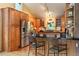 The kitchen features wood cabinets, black countertops, stainless appliances, and a breakfast bar with seating at 207 Kelly E Rd, Boulder, CO 80302