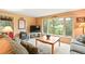 Cozy living room with large windows offering views of the surrounding trees at 207 Kelly E Rd, Boulder, CO 80302