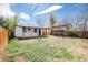 Backyard featuring a white house with a covered patio and a grassy area at 1941 Wabash St, Denver, CO 80220