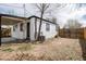 Backyard showcasing a white house with a small grassy area and wood fence at 1941 Wabash St, Denver, CO 80220