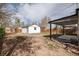 Backyard featuring a white house, a detached garage, a patio and a wood fence at 1941 Wabash St, Denver, CO 80220