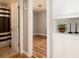 Bathroom entrance, showing tiling and shower, with hardwood floors on the right at 1941 Wabash St, Denver, CO 80220