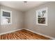 Bedroom featuring two windows, hardwood floors, and neutral-painted walls at 1941 Wabash St, Denver, CO 80220