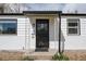 Close-up of the home's front door with black trim and decorative accents at 1941 Wabash St, Denver, CO 80220