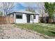 Cottage style home with gray roof and black trim. Partially xeriscaped at 1941 Wabash St, Denver, CO 80220