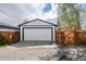 Garage featuring a white exterior, a large door and a black accent at 1941 Wabash St, Denver, CO 80220