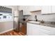 Bright kitchen with stainless steel fridge and dishwasher, plus modern countertop finishes at 1941 Wabash St, Denver, CO 80220