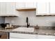 Detailed shot of the kitchen sink area with modern fixtures and stylish accents at 1941 Wabash St, Denver, CO 80220