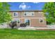 Backyard view of the home showcasing a patio, lawn, siding, and mature landscaping at 20145 E Fair Ln, Centennial, CO 80016