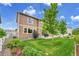 Well-maintained backyard with lawn, patio, landscaping, and a two-story house exterior at 20145 E Fair Ln, Centennial, CO 80016