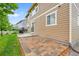 Exterior view of the backyard featuring a brick paver patio and lush green lawn at 20145 E Fair Ln, Centennial, CO 80016