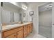 Bright bathroom featuring a double sink vanity, neutral color palette, and decorative accents at 20145 E Fair Ln, Centennial, CO 80016