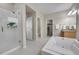 Bright bathroom featuring a glass-enclosed shower, soaking tub, and wood cabinets at 20145 E Fair Ln, Centennial, CO 80016