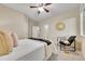 A bright bedroom with a ceiling fan and cozy chair near a window at 20145 E Fair Ln, Centennial, CO 80016