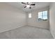 Empty bedroom with carpeted floor, ceiling fan and two sunny windows at 20145 E Fair Ln, Centennial, CO 80016