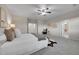 Spacious bedroom featuring plush carpeting, a ceiling fan, and natural light from the open doorway at 20145 E Fair Ln, Centennial, CO 80016
