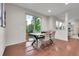 Dining room with decorative light fixture, large windows overlooking a manicured lawn at 20145 E Fair Ln, Centennial, CO 80016