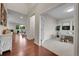 Open hallway with hardwood floors leading to a living room and an office with neutral carpet at 20145 E Fair Ln, Centennial, CO 80016