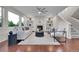Bright living room with a fireplace, built-in shelves, hardwood floors, and large windows at 20145 E Fair Ln, Centennial, CO 80016