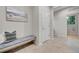 Mudroom area with convenient bench, hooks, and easy access to the laundry room at 20145 E Fair Ln, Centennial, CO 80016