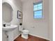 Contemporary powder room features a pedestal sink, modern mirror and natural light at 20145 E Fair Ln, Centennial, CO 80016