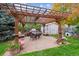 Brick patio with pergola, seating, and grill at 1255 Finch Ave, Brighton, CO 80601