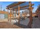 Landscaped backyard with wooden pergola and stone patio at 2415 E Maplewood Ave, Centennial, CO 80121