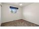 Bedroom with a large window with blue trim, neutral paint, and carpet floors at 2415 E Maplewood Ave, Centennial, CO 80121