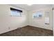 Carpeted bedroom features neutral paint, 2 windows and a mirror at 2415 E Maplewood Ave, Centennial, CO 80121