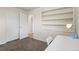 Bright bedroom featuring double closets, neutral walls and carpet, and built-in shelving at 2415 E Maplewood Ave, Centennial, CO 80121