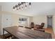 Dining area featuring modern chandelier and a long wooden table for gatherings and entertainment at 2415 E Maplewood Ave, Centennial, CO 80121