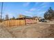 Corner lot with wood fence and partial view of home at 2415 E Maplewood Ave, Centennial, CO 80121