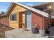 Welcoming front porch showcasing brick and wood siding and a well manicured outdoor space at 2415 E Maplewood Ave, Centennial, CO 80121