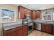 This warm kitchen offers dark wood cabinets and stainless appliances at 2415 E Maplewood Ave, Centennial, CO 80121