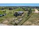 Scenic aerial view of a two-story home featuring a large yard, outbuildings, and surrounding trees at 36023 Winchester Rd, Elizabeth, CO 80107