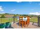 Outdoor deck with a wood table and chairs, greenery, and a scenic view at 36023 Winchester Rd, Elizabeth, CO 80107