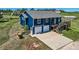 Bright blue exterior view of home, featuring an attached two-car garage and spacious driveway at 36023 Winchester Rd, Elizabeth, CO 80107