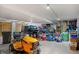 Spacious garage with ample storage space and a lawn mower at 36023 Winchester Rd, Elizabeth, CO 80107