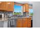 Bright kitchen with wooden cabinets, stone countertop, stainless steel appliances and a window view at 36023 Winchester Rd, Elizabeth, CO 80107