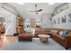 Open-concept living room featuring a skylight, hardwood floors, and plush sectional seating at 36023 Winchester Rd, Elizabeth, CO 80107